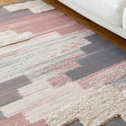 Piccolo tappeto rosa con frange decorative